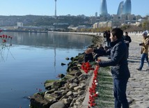 Baku residents bringing flowers to Seaside Boulevard to honor missing oil workers.  Azerbaijan, Dec.07, 2015